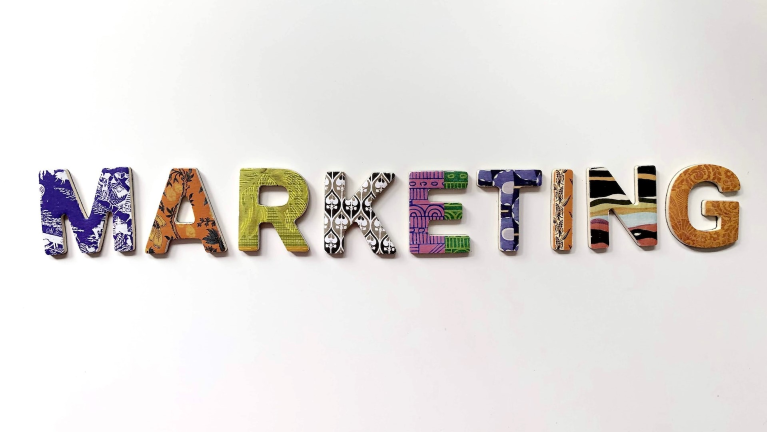 The word 'marketing' is written in different color letters